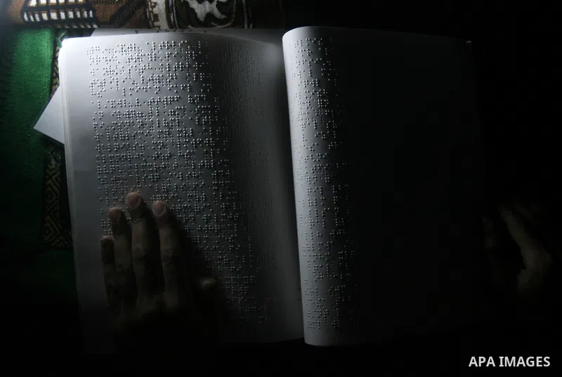 Palestinian Mahmoud Juhaish, 23, a blind youth studies at his house in Rafah refugee camp in southern Gaza strip on Feb. 17, 2014. Juhaish studies at the Islamic University in Gaza City as he suffers blindness, after his...