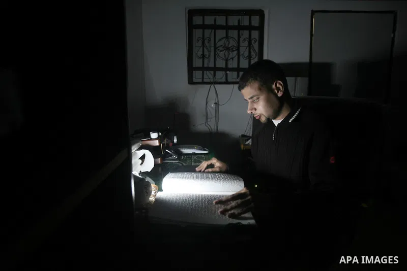 Palestinian Mahmoud Juhaish, 23, a blind youth studies at his house in Rafah refugee camp in southern Gaza strip on Feb. 17, 2014. Juhaish studies at the Islamic University in Gaza City as he suffers blindness, after his...