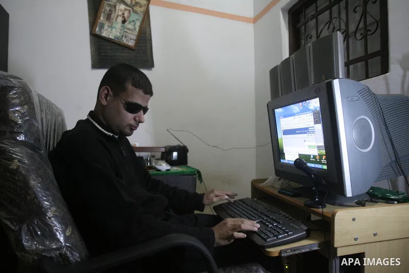 Palestinian Mahmoud Juhaish, 23, a blind youth studies at his house in Rafah refugee camp in southern Gaza strip on Feb. 17, 2014. Juhaish studies at the Islamic University in Gaza City as he suffers blindness, after his...