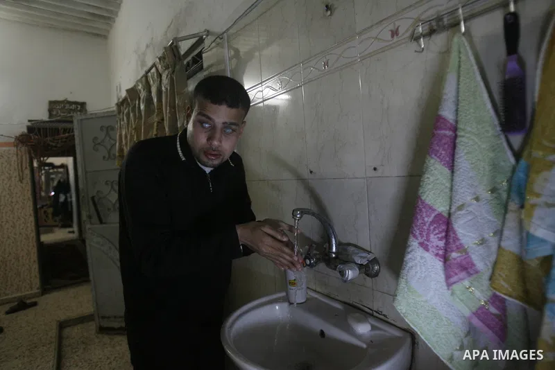 Palestinian Mahmoud Juhaish, 23, a blind youth washes his face at his house in Rafah refugee camp in southern Gaza strip on Feb. 17, 2014. Juhaish studies at the Islamic University in Gaza City as he suffers blindness, a...