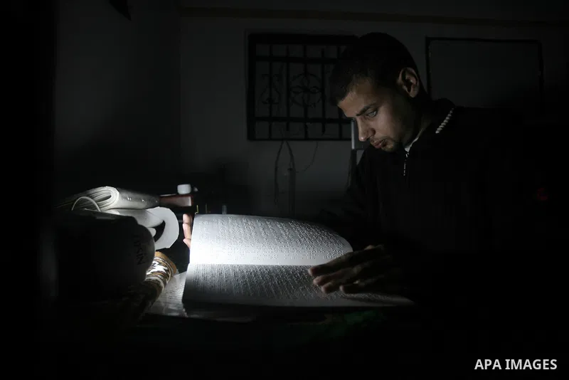Palestinian Mahmoud Juhaish, 23, a blind youth studies at his house in Rafah refugee camp in southern Gaza strip on Feb. 17, 2014. Juhaish studies at the Islamic University in Gaza City as he suffers blindness, after his...