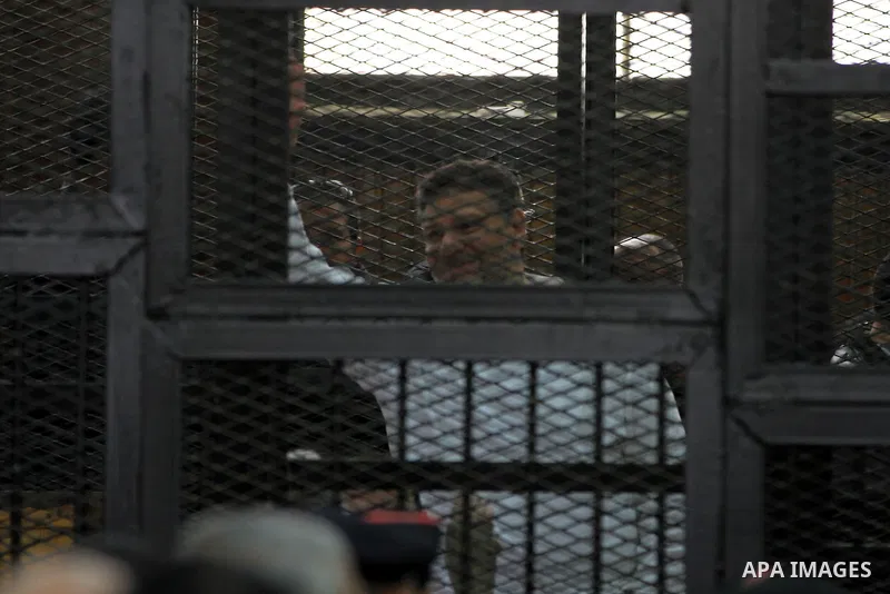 Egyptian members of Muslim Brotherhood, Mohamed Badie and Mohamed el-Beltagy during an initial court hearing held before the Shubra Al-Kheima Criminal Court in Cairo on February 17, 2014. A group of 48 Muslim Brotherhood...