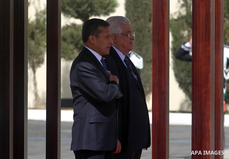 Palestinian President Mahmoud Abbas and his Peruvian counterpart Ollanta Humala walk past an honour guard during a welcoming ceremony in the West Bank city of Ramallah February 18 2014. Peruvian President Ollanta Humala...