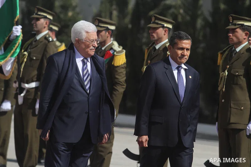Palestinian President Mahmoud Abbas and his Peruvian counterpart Ollanta Humala walk past an honour guard during a welcoming ceremony in the West Bank city of Ramallah February 18 2014. Peruvian President Ollanta Humala...