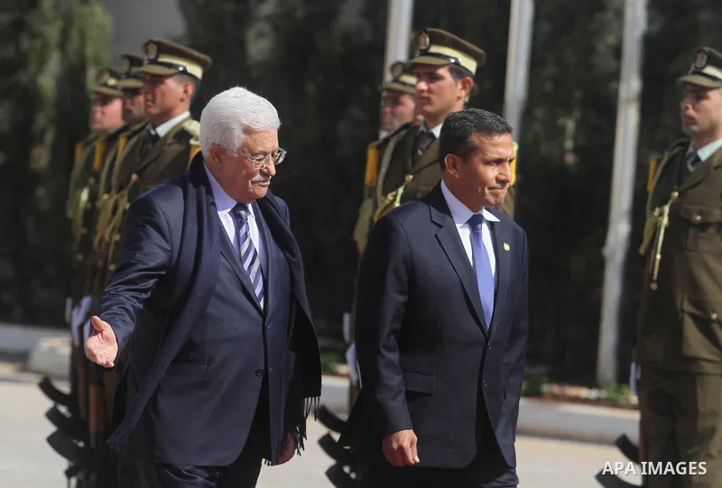 Palestinian President Mahmoud Abbas and his Peruvian counterpart Ollanta Humala walk past an honour guard during a welcoming ceremony in the West Bank city of Ramallah February 18 2014. Peruvian President Ollanta Humala...