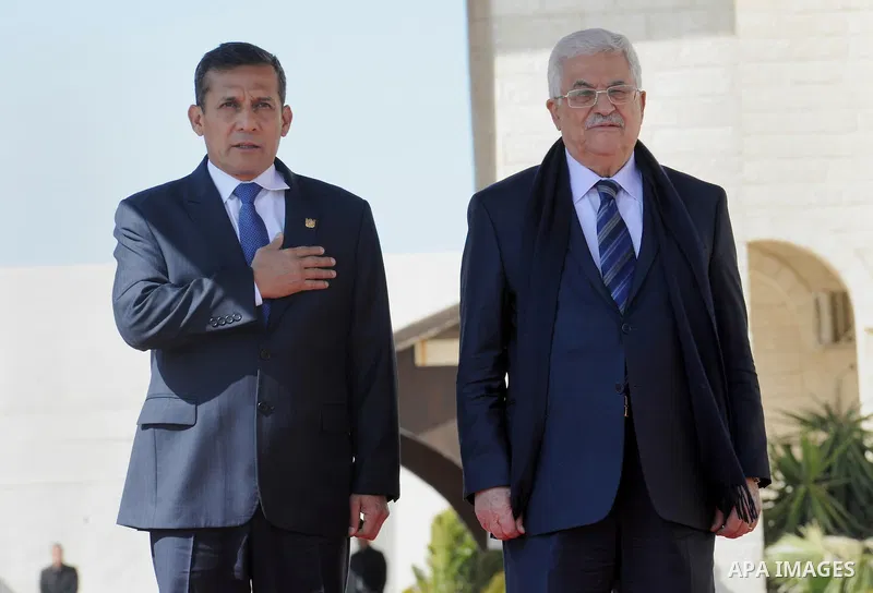 Palestinian President Mahmoud Abbas and his Peruvian counterpart Ollanta Humala walk past an honour guard during a welcoming ceremony in the West Bank city of Ramallah February 18 2014. Peruvian President Ollanta Humala...