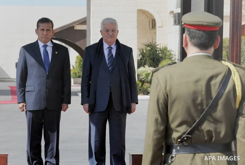 Palestinian President Mahmoud Abbas and his Peruvian counterpart Ollanta Humala walk past an honour guard during a welcoming ceremony in the West Bank city of Ramallah February 18 2014. Peruvian President Ollanta Humala...