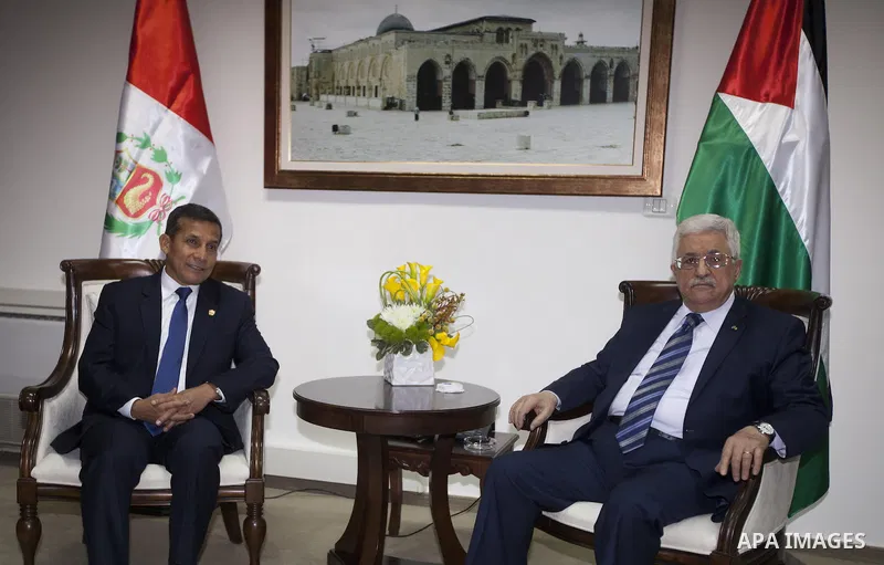 Palestinian President Mahmoud Abbas, right, shakes hands with the Peru's President Ollanta Humala in the West Bank city of Ramallah, Tuesday, Feb. 18, 2014. (APAIMAGES Photo/Majdi Mohammed, Pool)