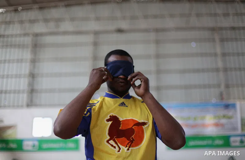 A Palestinian blind goalball player gets ready to play during a training course, in Gaza city on Feb. 18, 2014. Photo by Ashraf Amra