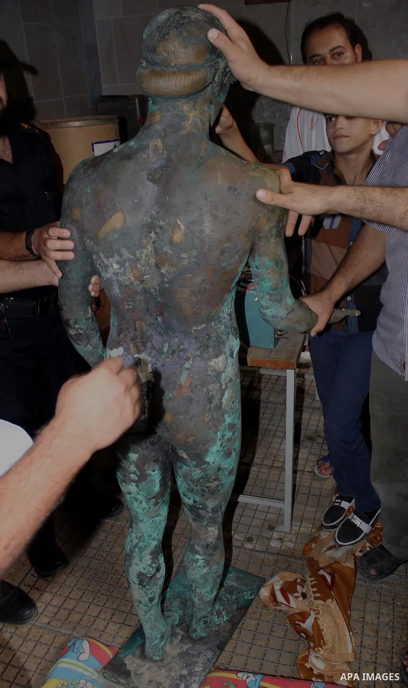 A picture taken on September 19, 2013 shows a 2,500-year-old bronze statue of the Greek god Apollo discovered by Palestinian fishermen last August. Lost for centuries, the rare bronze statue of the Greek God Apollo has m...
