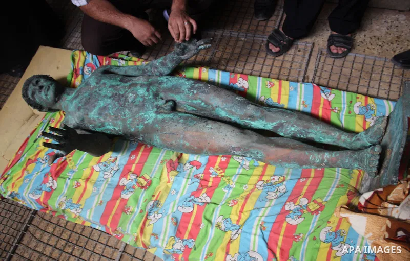 A picture taken on September 19, 2013 shows a 2,500-year-old bronze statue of the Greek god Apollo discovered by Palestinian fishermen last August. Lost for centuries, the rare bronze statue of the Greek God Apollo has m...