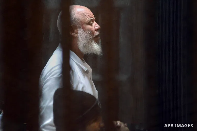Egyptian suspects in the case of the 'Nasr City terrorist cell' look from inside the defendants cage during their trial, in Cairo on February 18, 2014. Cairo Criminal Court of the Supreme State Security postponed Tuesday...