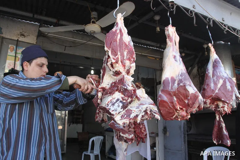 A Palestinian butcher cuts fresh meat at his slaughterhouse in Gaza city on Feb. 19, 2014. Palestinian butchers campaign discounts on prices of fresh meat to confront the sharp reduction in demand due to the blockaded te...
