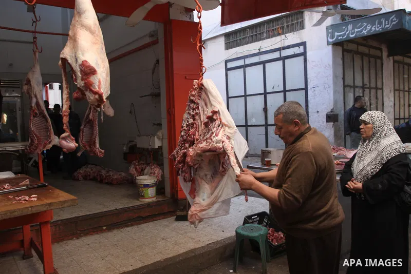 A Palestinian butcher cuts fresh meat at his slaughterhouse in Gaza city on Feb. 19, 2014. Palestinian butchers campaign discounts on prices of fresh meat to confront the sharp reduction in demand due to the blockaded te...