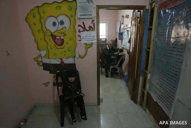 Mahmoud Abu Rous, 45, A Palestinian man teaches kids with speech disorder during a phonics lesson in Rafah in southern Gaza city, February 19, 2014. Abu Rous teaching kids the acquisition of all facets of language, from...