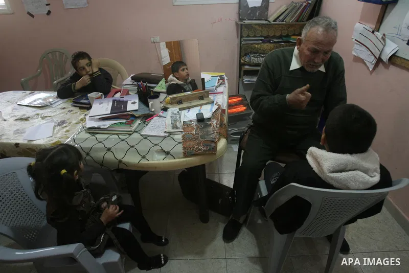 Mahmoud Abu Rous, 45, A Palestinian man teaches kids with speech disorder during a phonics lesson in Rafah in southern Gaza city, February 19, 2014. Abu Rous teaching kids the acquisition of all facets of language, from...