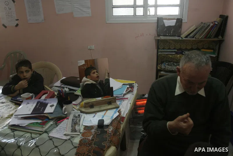 Mahmoud Abu Rous, 45, A Palestinian man teaches kids with speech disorder during a phonics lesson in Rafah in southern Gaza city, February 19, 2014. Abu Rous teaching kids the acquisition of all facets of language, from...