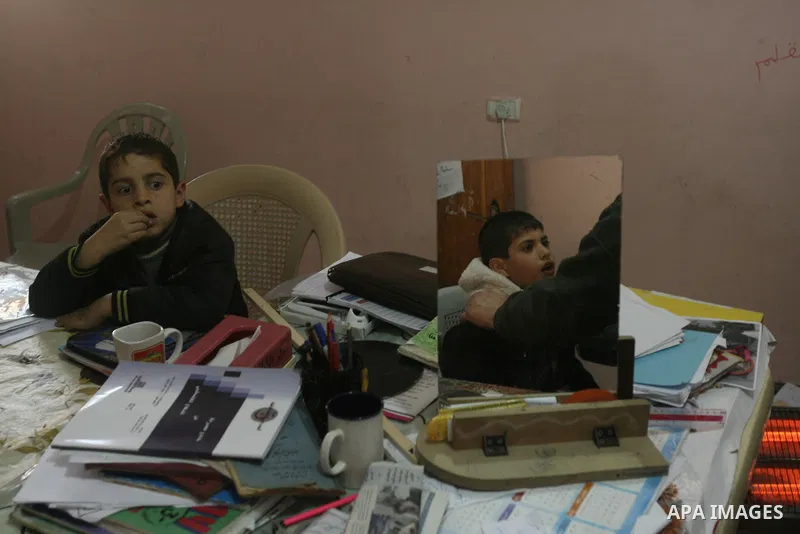 Mahmoud Abu Rous, 45, A Palestinian man teaches kids with speech disorder during a phonics lesson in Rafah in southern Gaza city, February 19, 2014. Abu Rous teaching kids the acquisition of all facets of language, from...