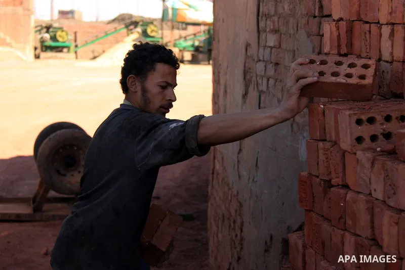 An Egyptian laborer works at a brick factory facility in the suburb of Helwan, Cairo, Egypt on February 19, 2014. Egypt’s unemployment rate remained unchanged in the fourth quarter of 2013 at 13.4 percent of a labour for...