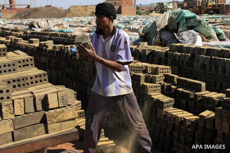 An Egyptian laborer works at a brick factory facility in the suburb of Helwan, Cairo, Egypt on February 19, 2014. Egypt’s unemployment rate remained unchanged in the fourth quarter of 2013 at 13.4 percent of a labour for...