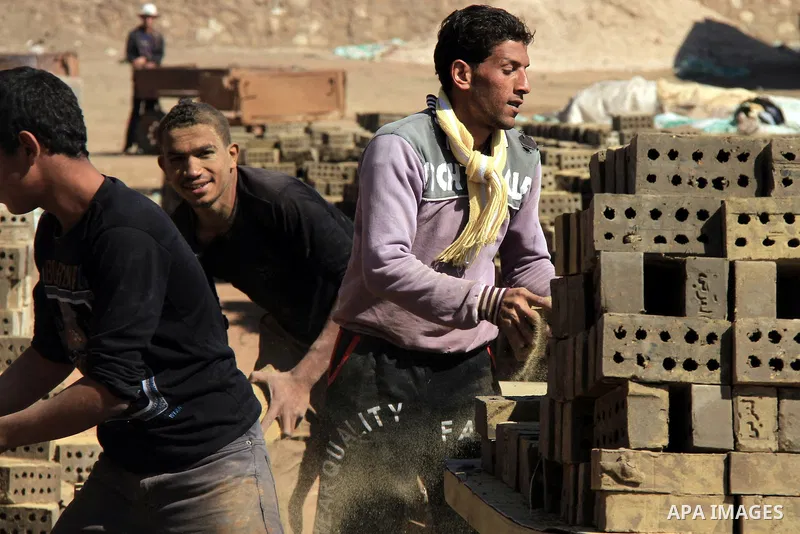 Egyptian laborers work at a brick factory facility in the suburb of Helwan, Cairo, Egypt on February 19, 2014. Egypt’s unemployment rate remained unchanged in the fourth quarter of 2013 at 13.4 percent of a labour force...