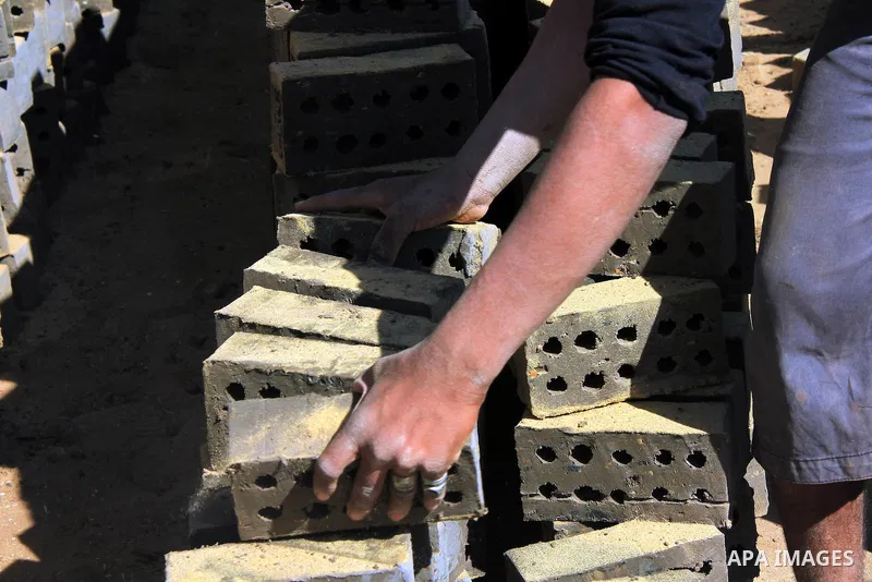 An Egyptian laborer works at a brick factory facility in the suburb of Helwan, Cairo, Egypt on February 19, 2014. Egypt’s unemployment rate remained unchanged in the fourth quarter of 2013 at 13.4 percent of a labour for...