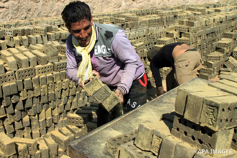 An Egyptian laborer works at a brick factory facility in the suburb of Helwan, Cairo, Egypt on February 19, 2014. Egypt’s unemployment rate remained unchanged in the fourth quarter of 2013 at 13.4 percent of a labour for...