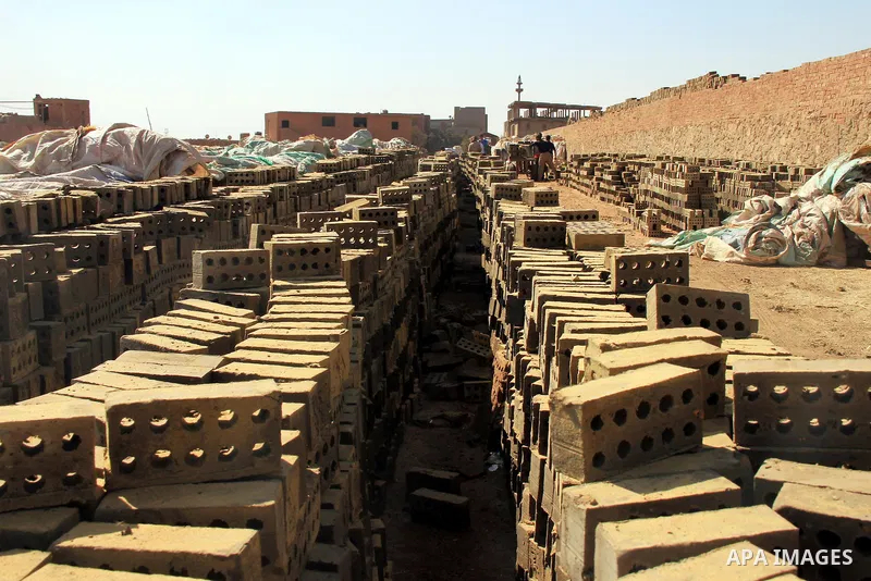 Egyptian laborers work at a brick factory facility in the suburb of Helwan, Cairo, Egypt on February 19, 2014. Egypt’s unemployment rate remained unchanged in the fourth quarter of 2013 at 13.4 percent of a labour force...