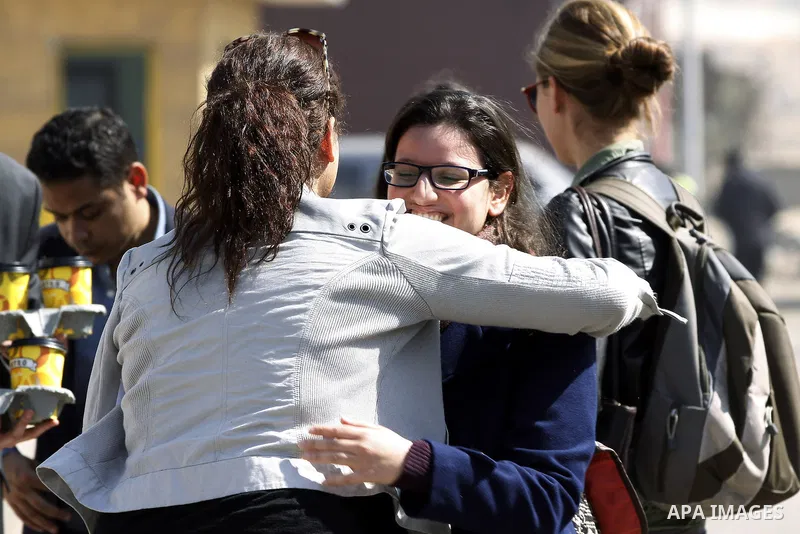 Journalists wait outside court adjacent to Tora prison as 20 Al-Jazeera employees are on trial accused of membership in the Muslim Brotherhood and also for aiding it in Cairo, Egypt, Thursday, Feb. 20, 2014. A rights gro...