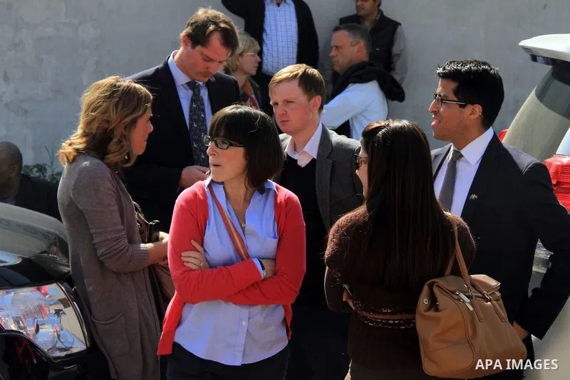 Journalists wait outside court adjacent to Tora prison as 20 Al-Jazeera employees are on trial accused of membership in the Muslim Brotherhood and also for aiding it in Cairo, Egypt, Thursday, Feb. 20, 2014. A rights gro...