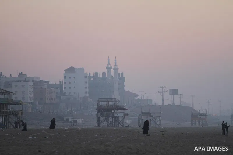 Palestinian enjoy the beach under heavy fog at the Mediterranean Sea beach front in Gaza City, Thursday, Feb. 20, 2014. Photo by Mohammed Asad