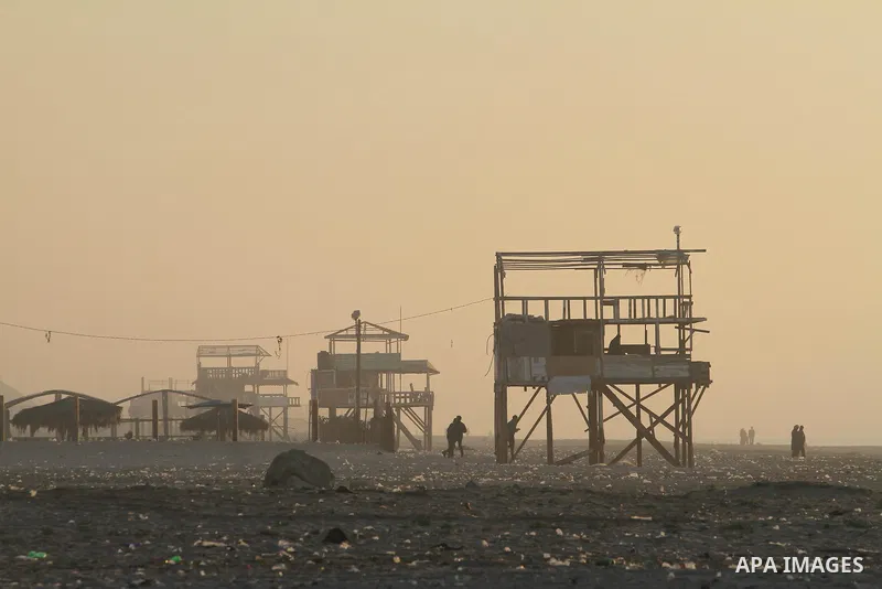 Palestinian enjoy the beach under heavy fog at the Mediterranean Sea beach front in Gaza City, Thursday, Feb. 20, 2014. Photo by Mohammed Asad