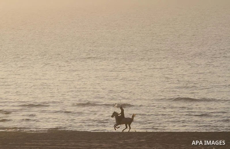 A Palestinian man rides his horse under heavy fog at the Mediterranean Sea beach front in Gaza City, Thursday, Feb. 20, 2014. Photo by Mohammed Asad