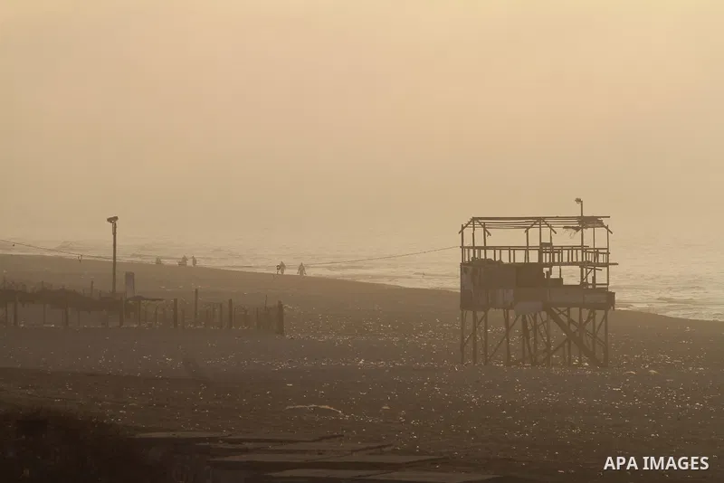 Palestinian enjoy the beach under heavy fog at the Mediterranean Sea beach front in Gaza City, Thursday, Feb. 20, 2014. Photo by Mohammed Asad