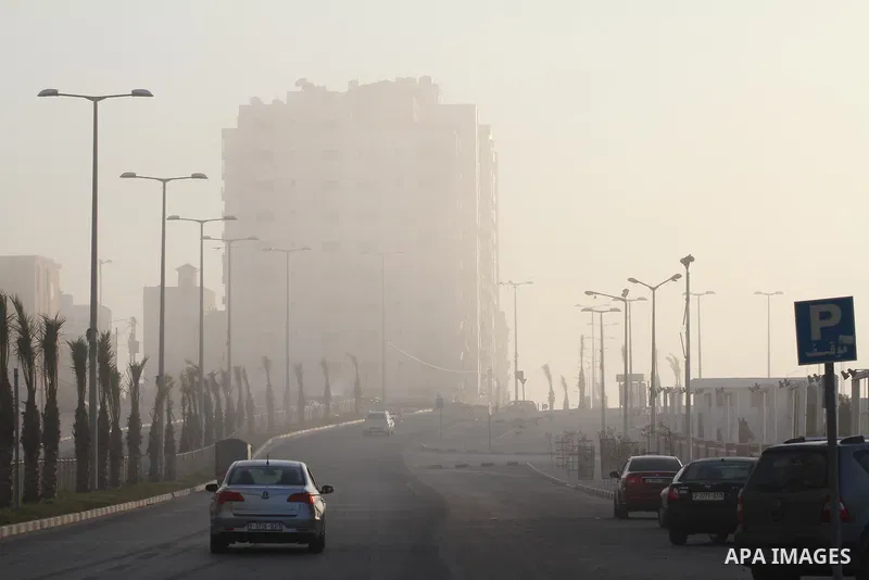 Cars are driven under heavy fog at the Mediterranean Sea beach front in Gaza City, Thursday, Feb. 20, 2014. Photo by Mohammed Asad