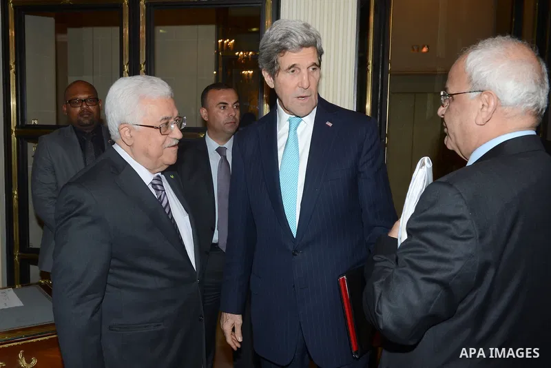 Palestinian President Mahmud Abbas and Palestinian Chief of Negotiator Saeb Erekat meet with US Secretary of State John Kerry for their second round of talks in two days on February 20, 2014 in Paris. The two men met for...