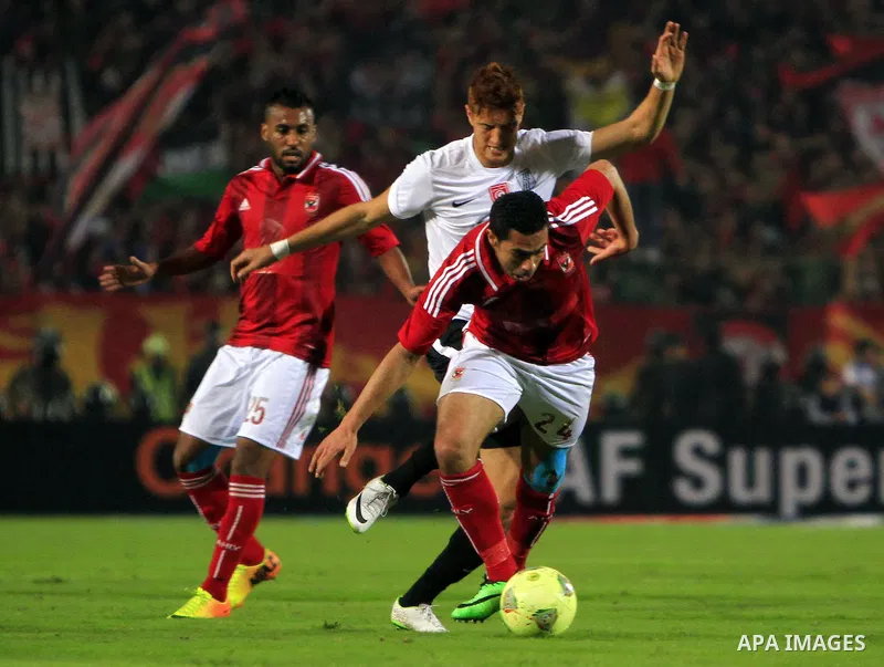 Egyptian players of Al-Ahly club compete with Tunisia's CS Sfaxien during their African Super Cup soccer match at Cairo Stadium February 20, 2014. Photo by Mohammed Bendari