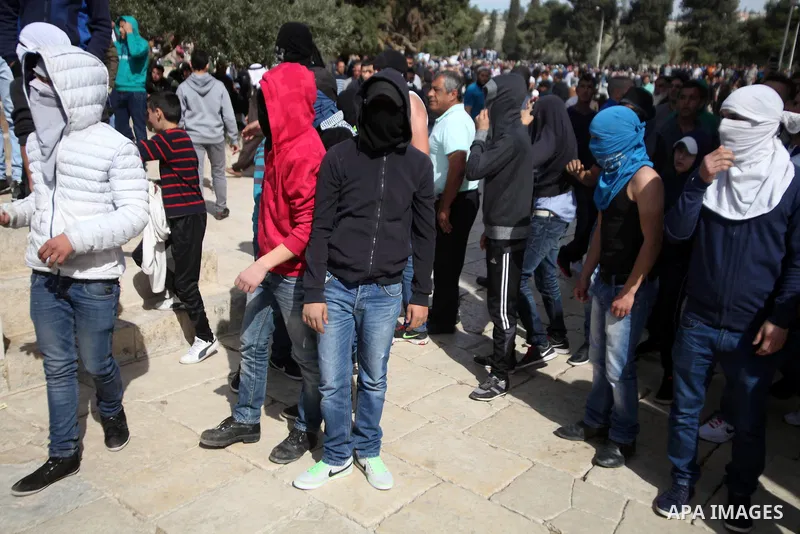 Masked Palestinian youth gather as they tr to enter the yard of Western Wall following the Friday prayers at the Al-Aqsa compound, Islam's third holiest site, in the old city of Jerusalem February 21, 2014. Photo by Saee...
