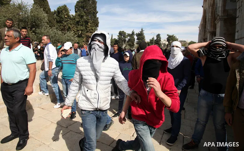 Masked Palestinian youth gather as they tr to enter the yard of Western Wall following the Friday prayers at the Al-Aqsa compound, Islam's third holiest site, in the old city of Jerusalem February 21, 2014. Photo by Saee...