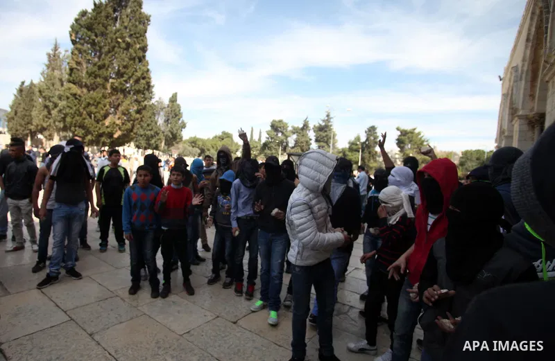 Masked Palestinian youth gather as they tr to enter the yard of Western Wall following the Friday prayers at the Al-Aqsa compound, Islam's third holiest site, in the old city of Jerusalem February 21, 2014. Photo by Saee...