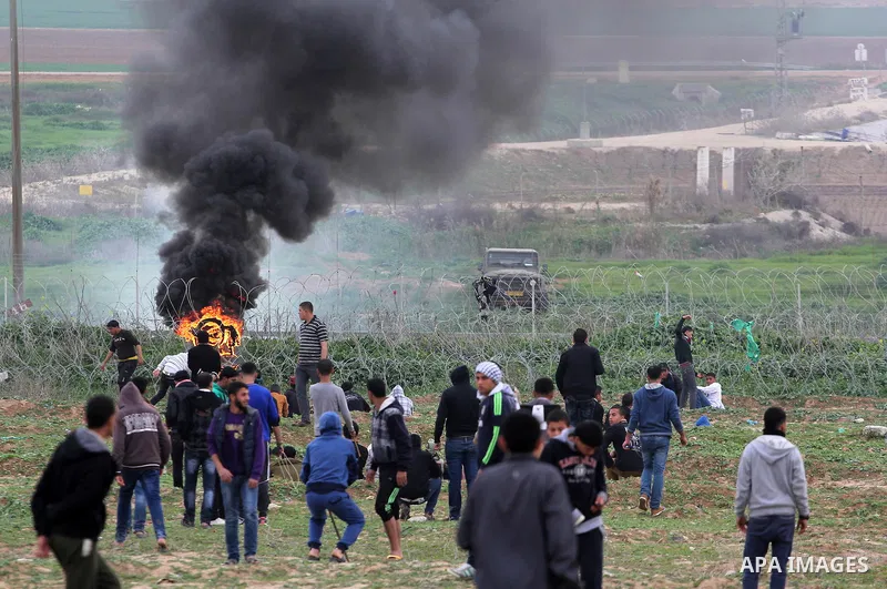 Palestinian protesters throw stones at Israeli security forces during clashes near the border with Israel, east of Jabalia refugee camp in northern Gaza Strip on February 21, 2014. The Israeli army fired live rounds and...