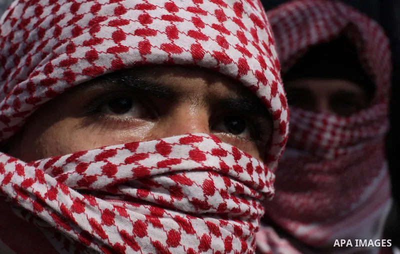 Masked Palestinian supporters of the Popular Resistance Movement take part in a protest in solidarity with Muslims in Central African Republic, in front of the headquarter United Nation "UNSCO" in Gaza city, February 22,...