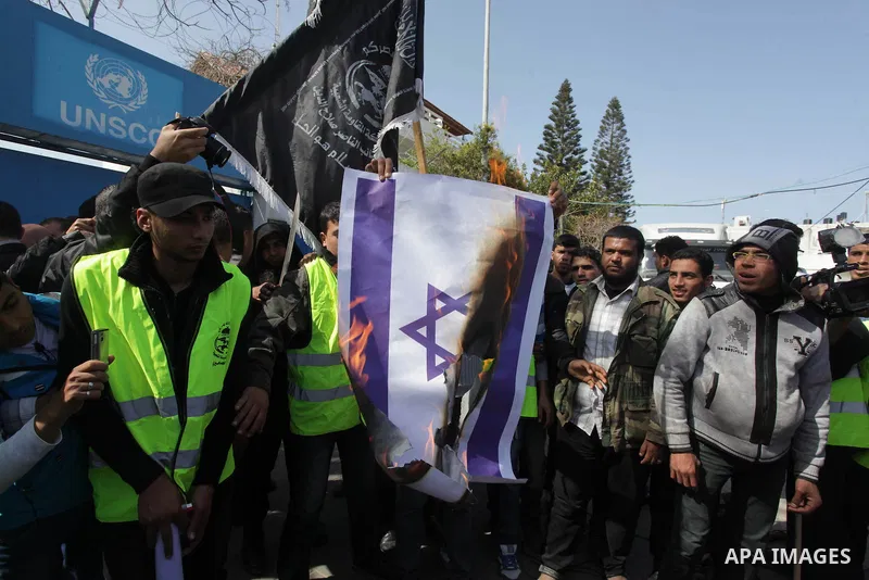 Palestinian supporters of the Popular Resistance Movement, burn a Israeli flag during a protest in solidarity with Muslims in Central African Republic, in front of the headquarter United Nation "UNSCO" in Gaza city, Febr...