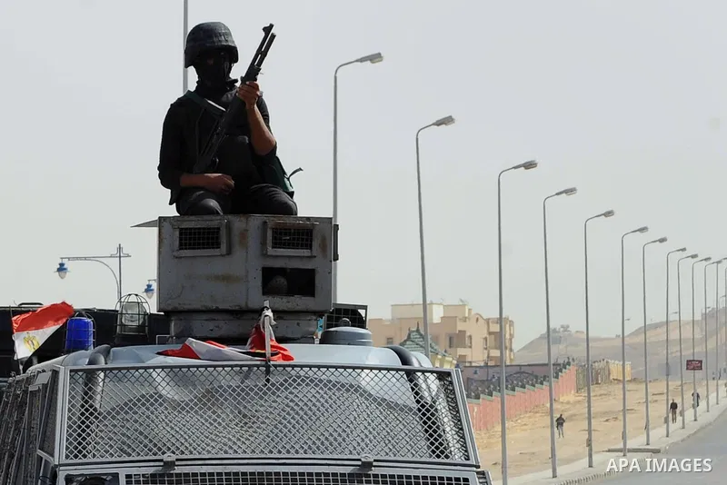 Egyptian security forces stand guard as ousted Egyptian president Morsi and 14 other defendants arrive at Cairo's Police Academy, cairo, on Feb. 22, 2014. Morsi, toppled in July by the military, faces a host of criminal...