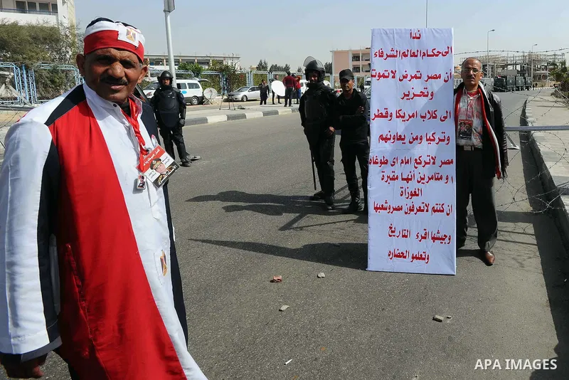 Egyptian supporters of Egypt's army chief Field Marshal Abdel Fattah al-Sisi take part a protest outside a police academy, on Feb. 22, 2014. Morsi, toppled in July by the military, faces a host of criminal charges and ap...