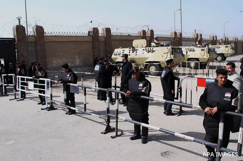 Egyptian security forces stand guard as ousted Egyptian president Morsi and 14 other defendants arrive at Cairo's Police Academy, cairo, on Feb. 22, 2014. Morsi, toppled in July by the military, faces a host of criminal...