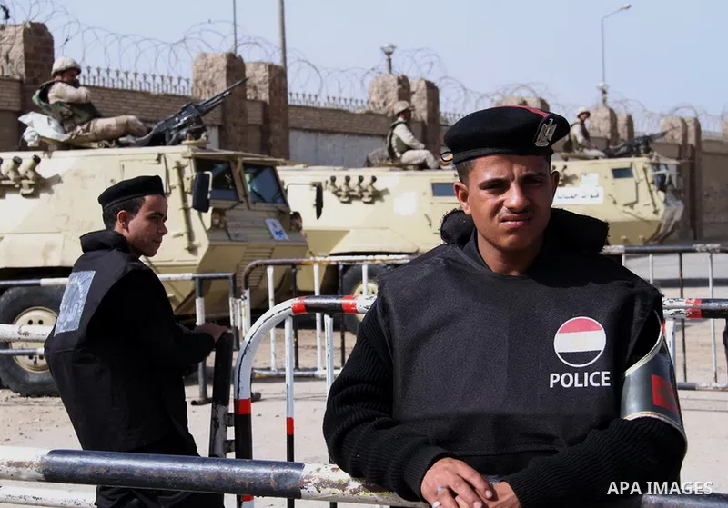 Egyptian security forces stand guard as ousted Egyptian president Morsi and 14 other defendants arrive at Cairo's Police Academy, cairo, on Feb. 22, 2014. Morsi, toppled in July by the military, faces a host of criminal...