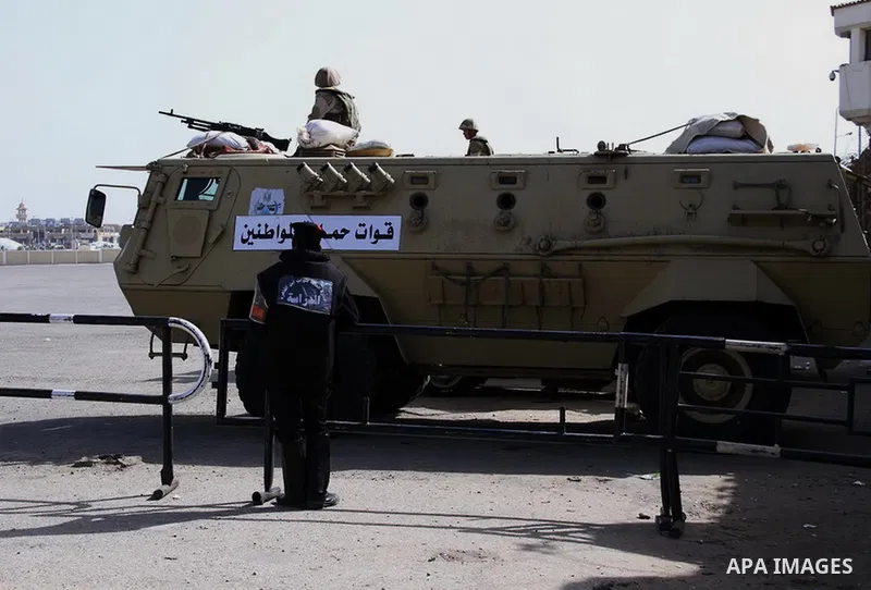 Egyptian security forces stand guard as ousted Egyptian president Morsi and 14 other defendants arrive at Cairo's Police Academy, cairo, on Feb. 22, 2014. Morsi, toppled in July by the military, faces a host of criminal...
