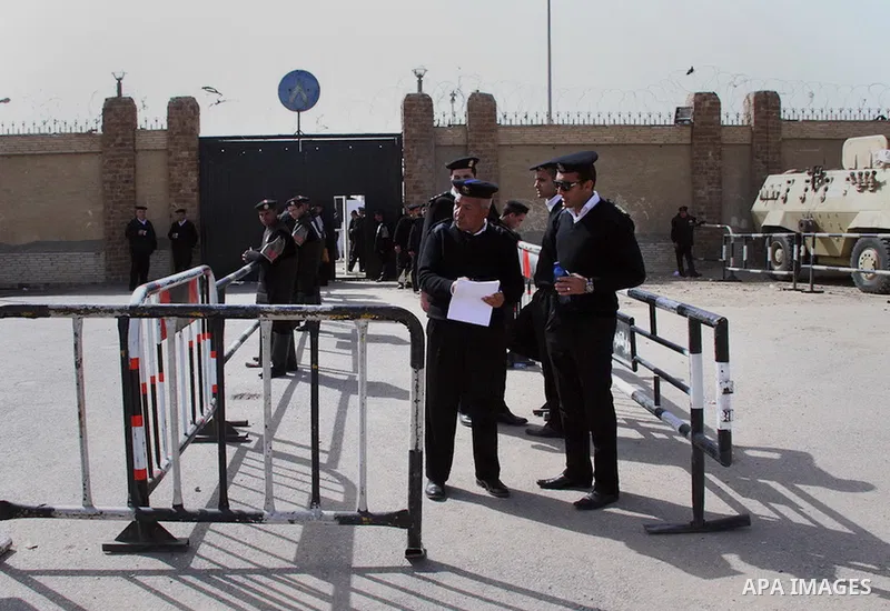 Egyptian security forces stand guard as ousted Egyptian president Morsi and 14 other defendants arrive at Cairo's Police Academy, cairo, on Feb. 22, 2014. Morsi, toppled in July by the military, faces a host of criminal...