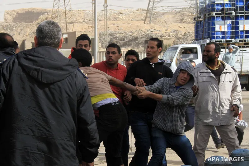 Relatives of the 'Ultras of Revolutionary' who support Muslim Brotherhood clashes with Egyptian security forces outside the Tora jail in Cairo, on Feb. 22, 2014. The court accused the group of violating the demonstration...